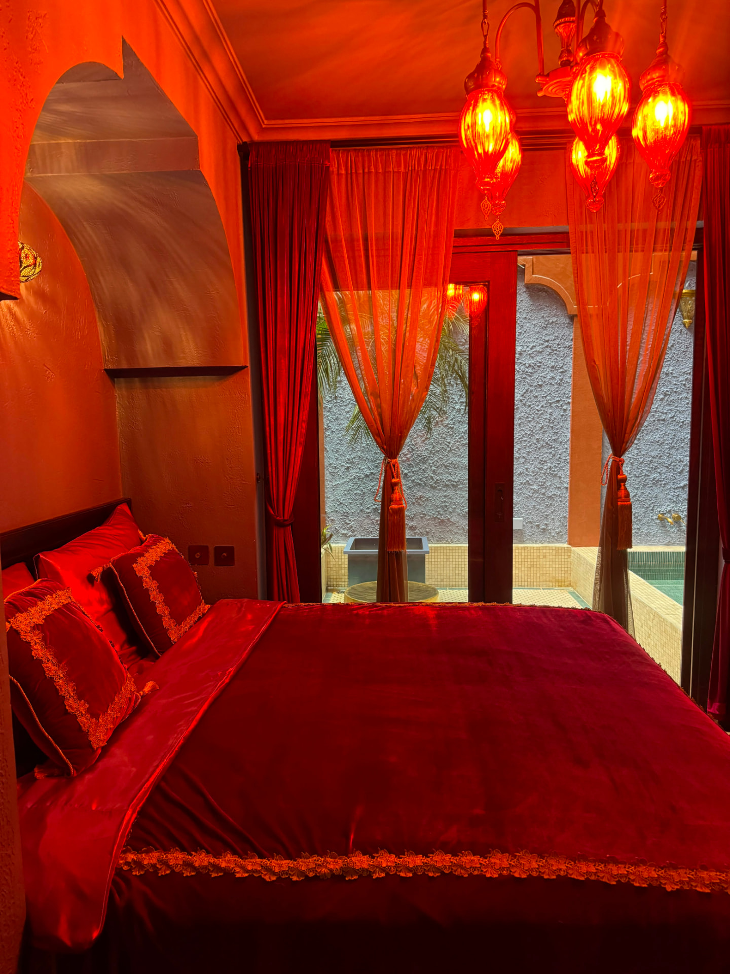 Lantern-lit riad suite with velvet bedding opening onto a private plunge pool