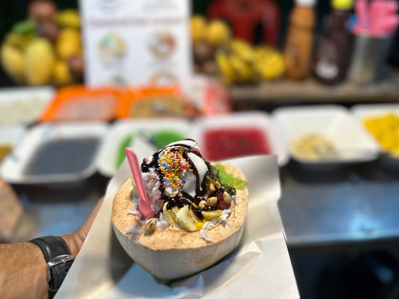 Coconut ice cream loaded with fruit at a Thai street-food stall