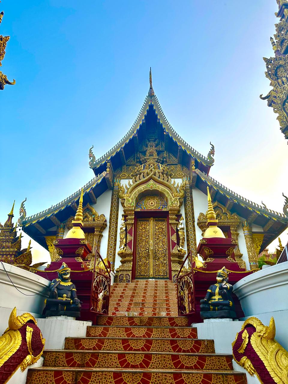 Golden Lanna temple beneath a blue sky in northern Thailand